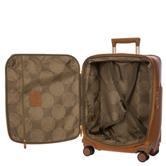 Bric's Cabin Spinner Suitcase Pelle in tan with four spinner wheels and a durable hard shell for travel.