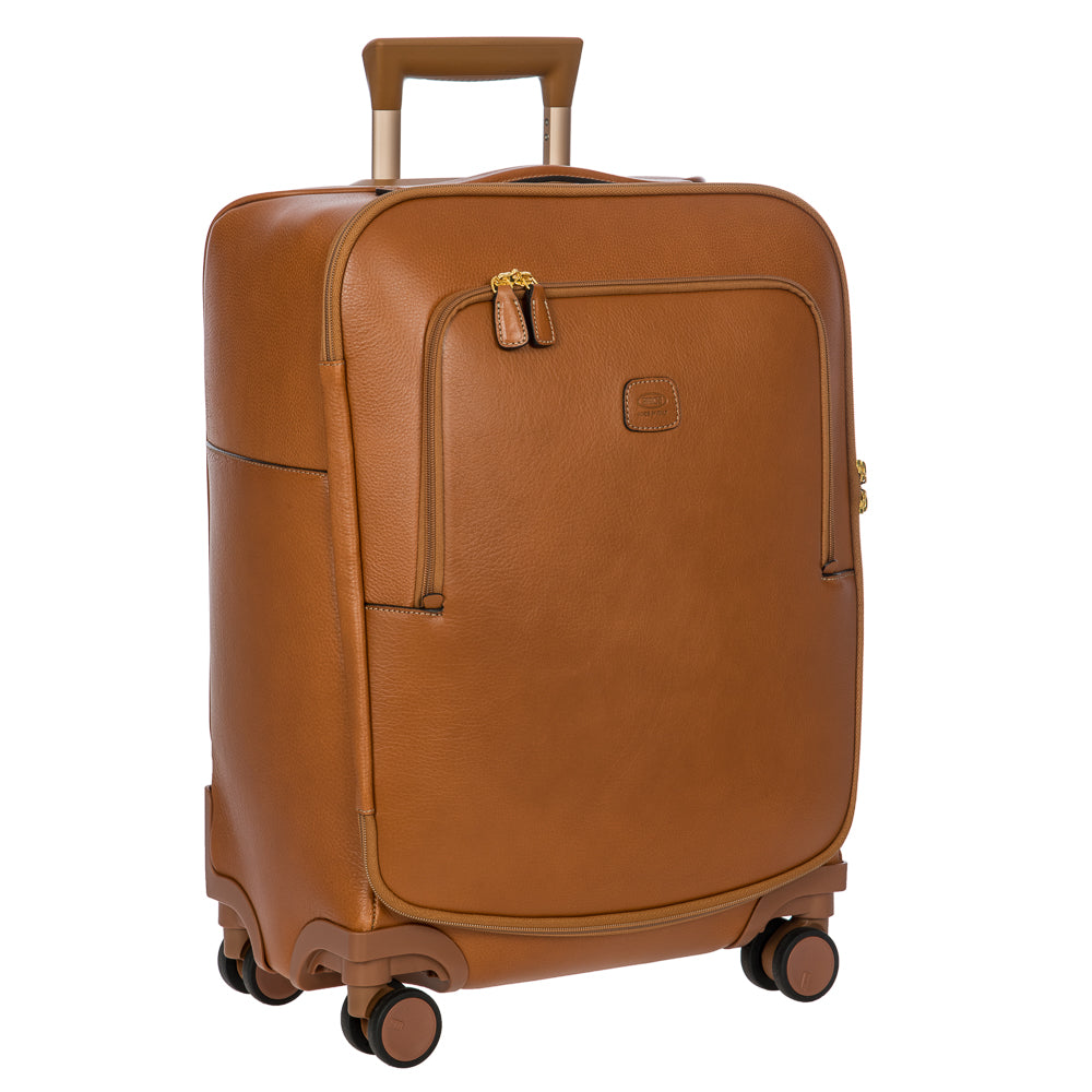Bric's Cabin Spinner Suitcase Pelle in tan leather with four spinning wheels and sturdy handle, designed for travel.