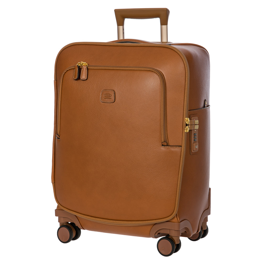 Tan Bric's Cabin Spinner Suitcase with four wheels and sturdy handle, designed for travel and easy maneuverability.