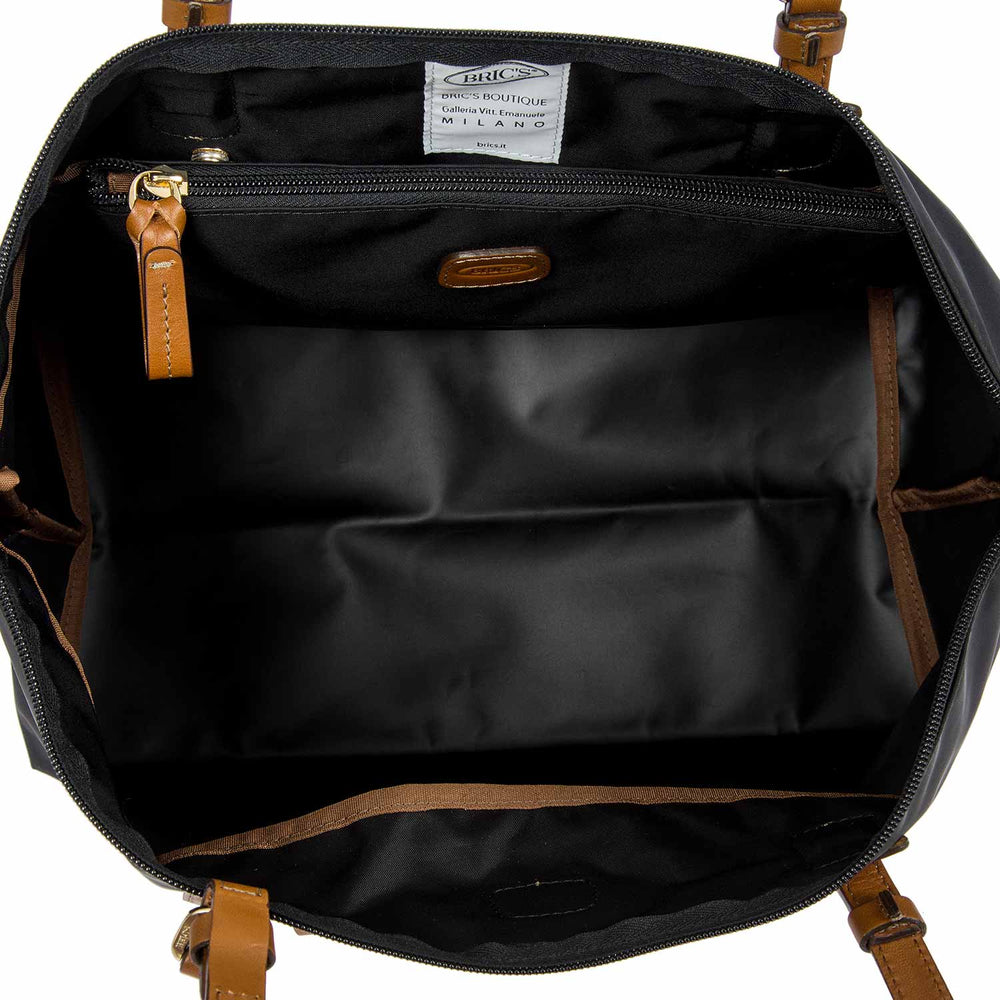 Large black Sportina duffle bag by Bric's, featuring sturdy handles and a spacious interior for travel or gym use.