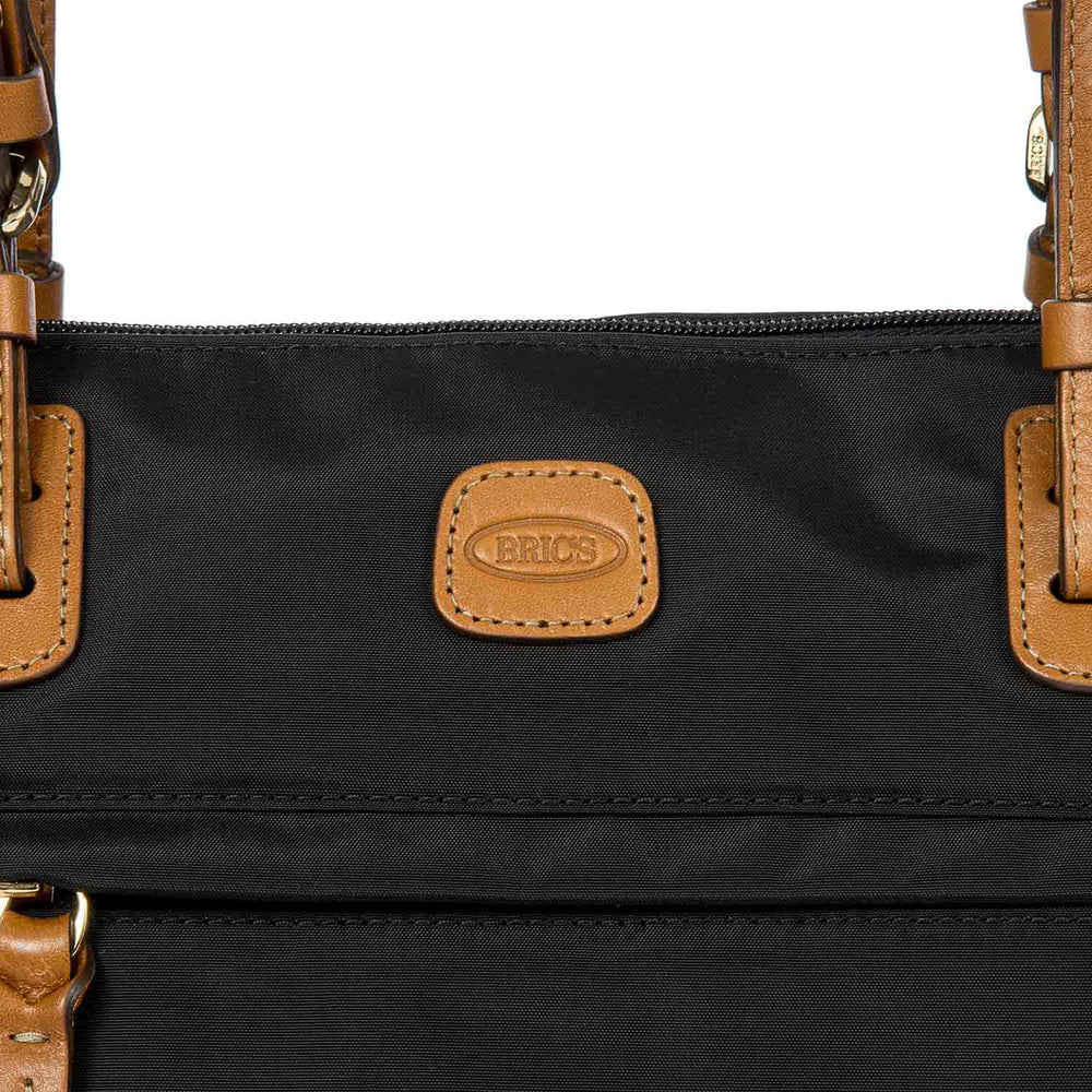 Large black Sportina duffle bag by Bric's, featuring sturdy handles and a spacious interior for travel essentials.