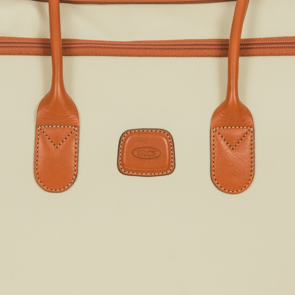 Cream Bric's large trolley duffle bag from the Firenze collection, showing the spacious design and sturdy wheels.