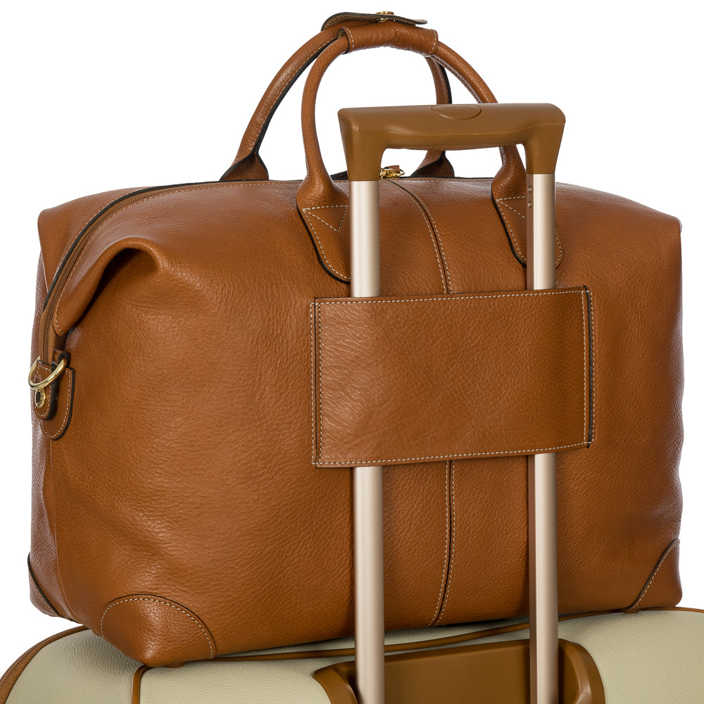 Tan Bric's small holdall made of Pelle leather, showing its compact design and sturdy handles for travel and everyday use.