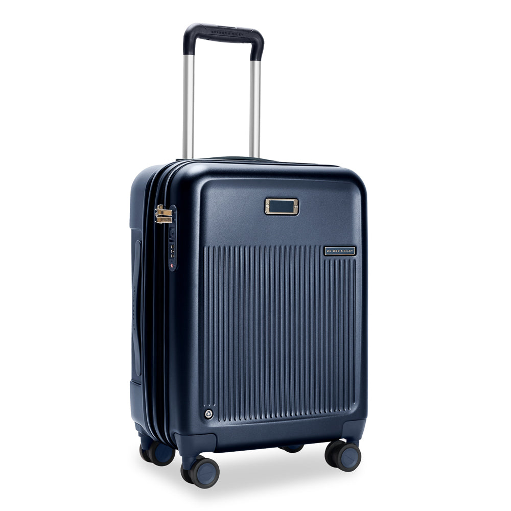 Navy 53cm expandable carry-on spinner suitcase by Briggs & Riley, featuring smooth wheels and a durable design.