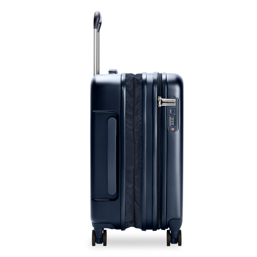 Navy 53cm expandable carry-on spinner suitcase by Briggs & Riley, featuring wheels and a zipper for easy travel.