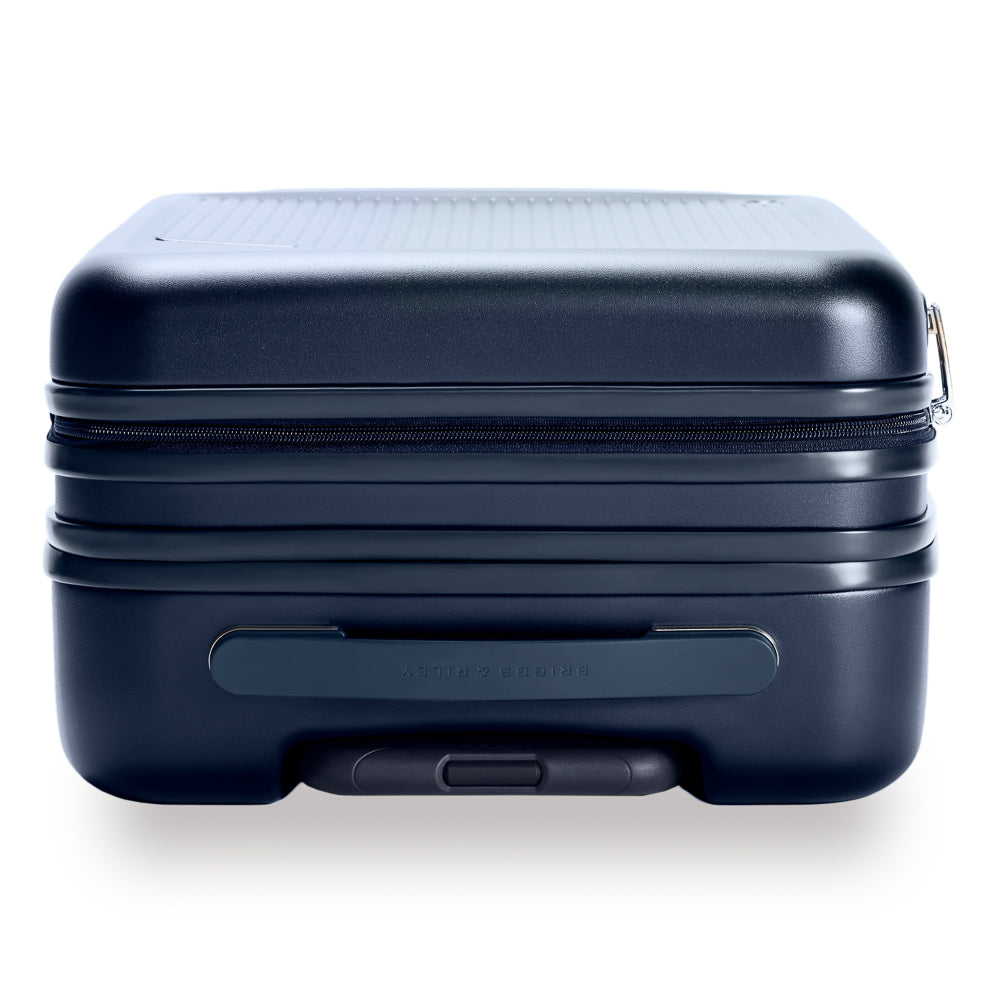 Navy Briggs & Riley 53cm expandable carry-on spinner suitcase with smooth wheels and sturdy handle for easy travel.