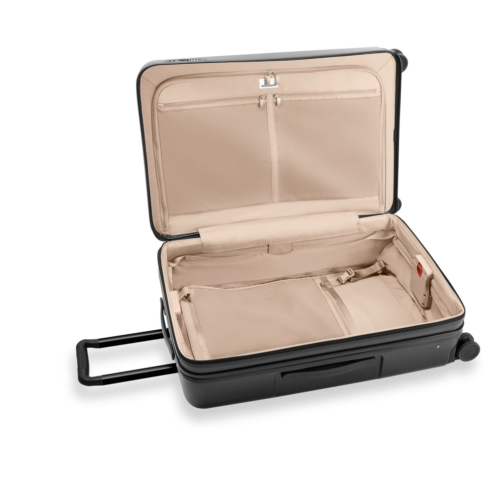 Briggs & Riley Sympatico 3.0 large expandable spinner suitcase in black, featuring wheels and sturdy handles for travel.