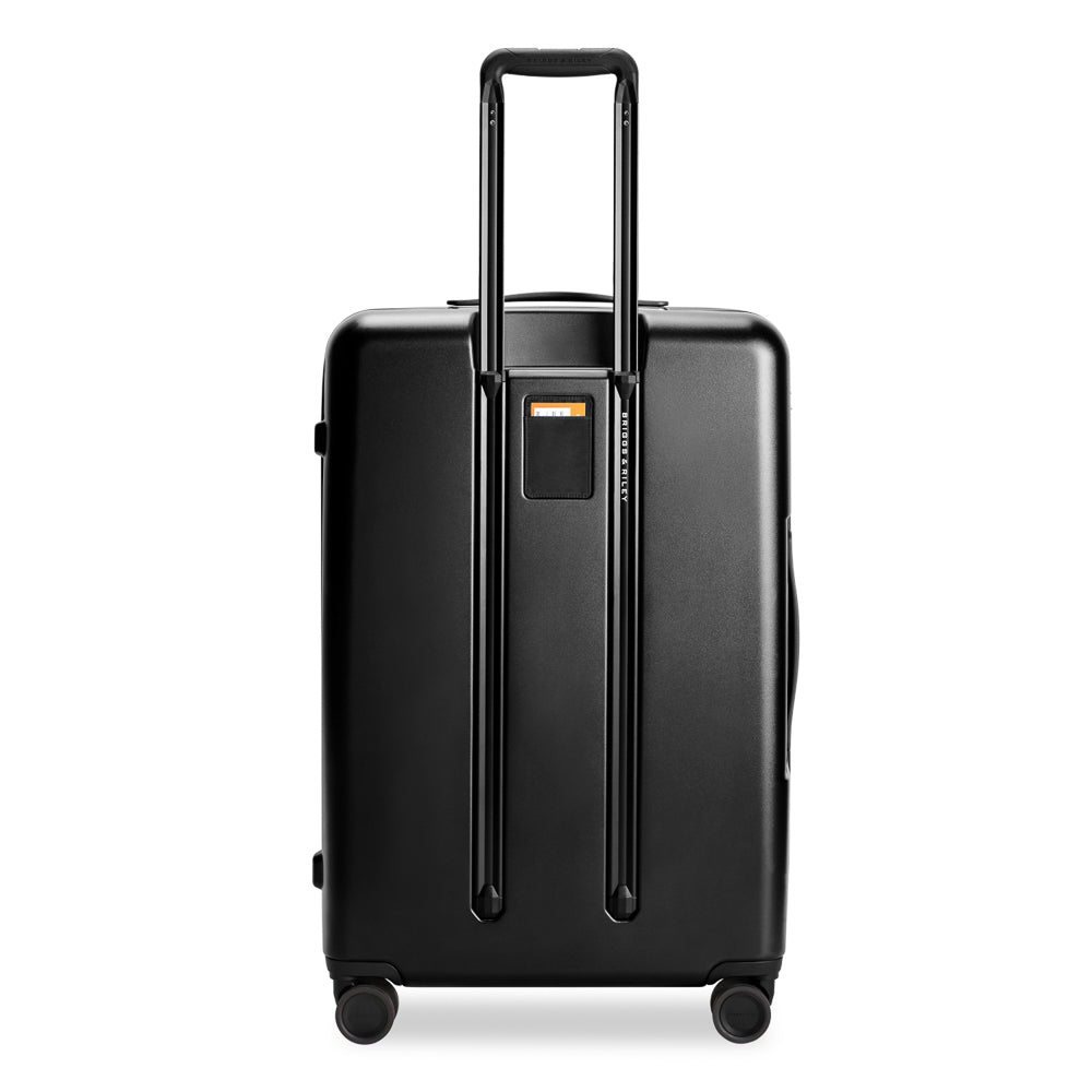 Large black expandable spinner suitcase by Briggs & Riley, featuring durable exterior and four smooth-rolling wheels.