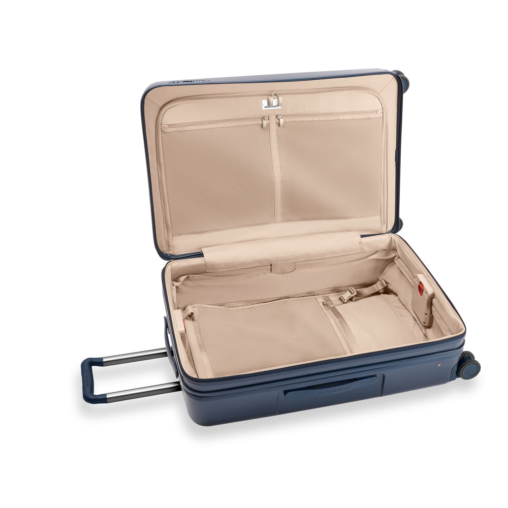 Large 76cm expandable spinner suitcase in navy by Briggs & Riley, featuring smooth wheels and durable fabric.