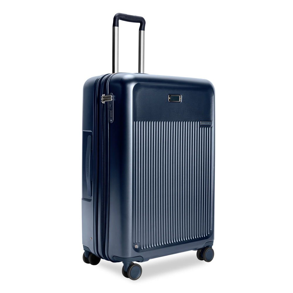 Briggs & Riley Sympatico 3.0 large expandable spinner suitcase in navy, featuring durable design and smooth-rolling wheels.
