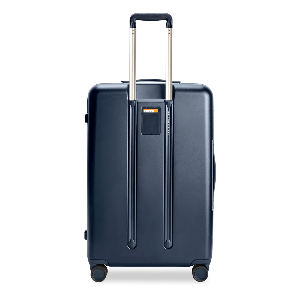 Large 76cm navy expandable spinner suitcase by Briggs & Riley, showcasing durable fabric and smooth-rolling wheels.