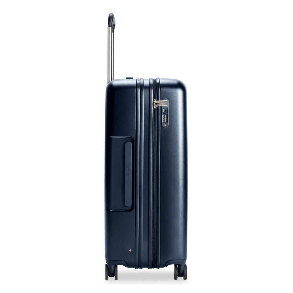 Large navy Briggs & Riley Sympatico 3.0 expandable spinner suitcase with wheels and sturdy handle for check-in travel.