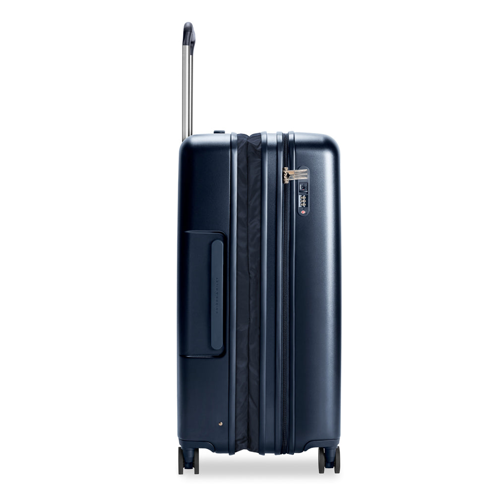 Large expandable spinner suitcase in navy by Briggs & Riley, showcasing durable material and spacious compartments.