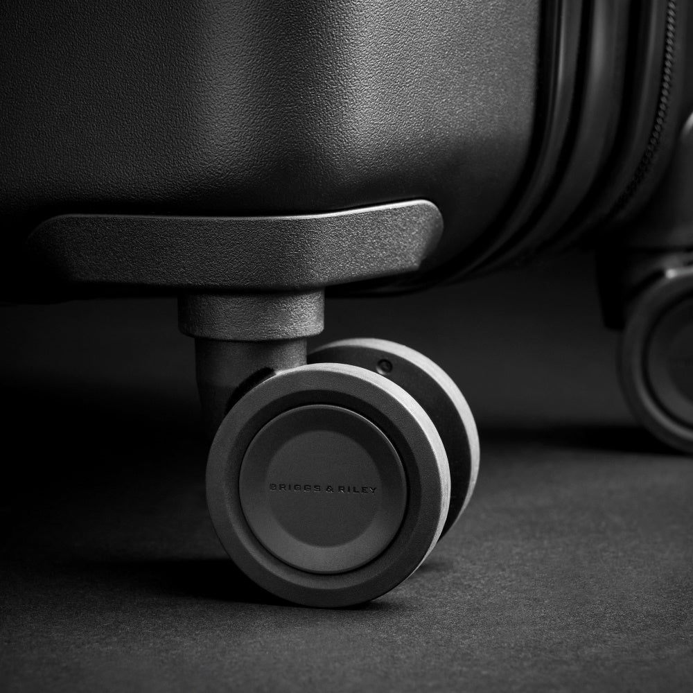 Briggs & Riley Sympatico 3.0 extra large black spinner suitcase with four wheels and spacious interior for travel.