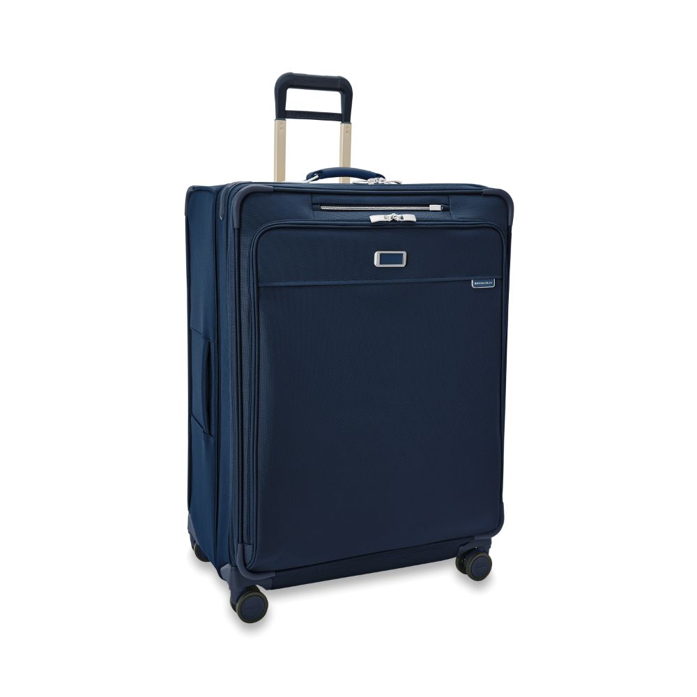 Extra large expandable spinner suitcase in navy by Briggs & Riley, featuring four wheels and sturdy handle for easy transport.