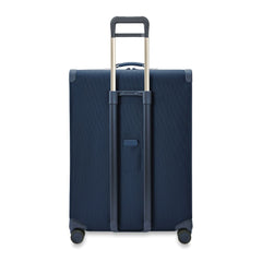 Extra large expandable spinner suitcase in navy by Briggs & Riley, featuring multiple compartments and sturdy wheels.