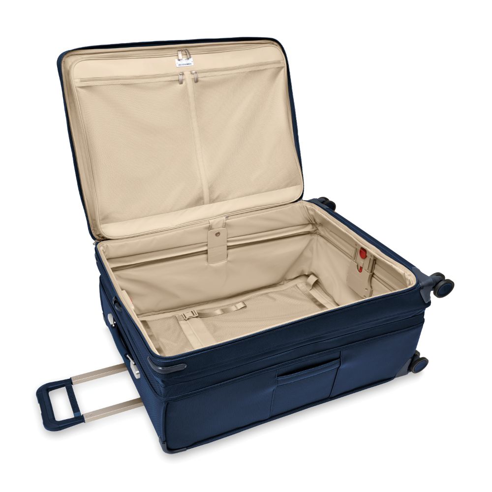 Extra large expandable spinner suitcase in navy by Briggs & Riley, featuring smooth wheels and spacious interior for travel.