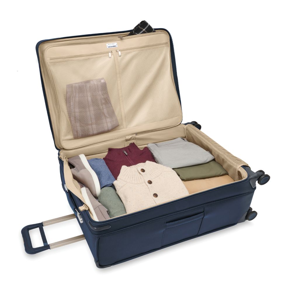 Extra large expandable spinner suitcase in navy from Briggs & Riley, featuring smooth wheels and a durable design.