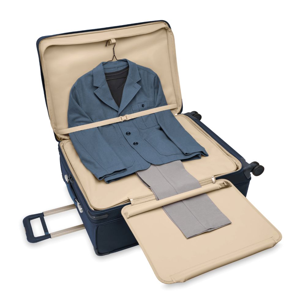 Briggs & Riley Baseline 2 extra large expandable spinner suitcase in navy, featuring four wheels and a spacious interior.