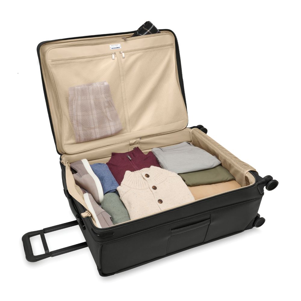 Extra large expandable black spinner suitcase from Briggs & Riley, featuring a durable design for check-in luggage.