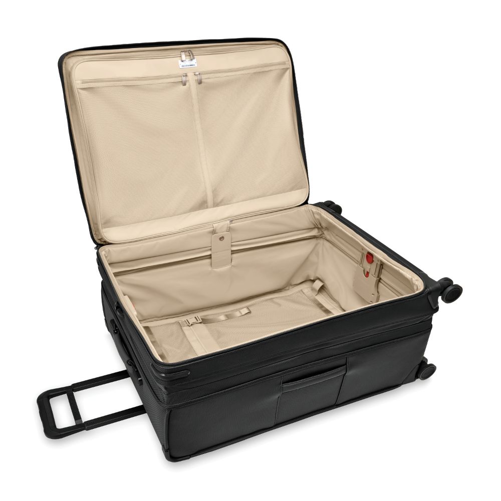 Extra large black Briggs & Riley Baseline 2 expandable spinner suitcase with smooth wheels and sturdy handle.