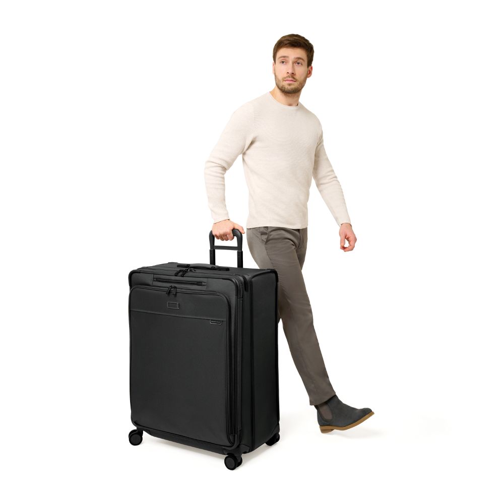 Extra large Briggs & Riley Baseline 2 expandable spinner suitcase in black with smooth wheels and sturdy handle.