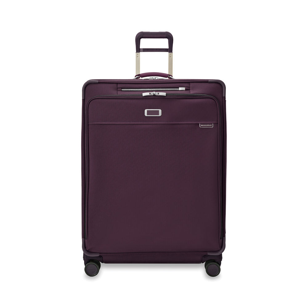 Extra large expandable spinner suitcase in plum by Briggs & Riley, showcasing durable fabric and smooth wheels.
