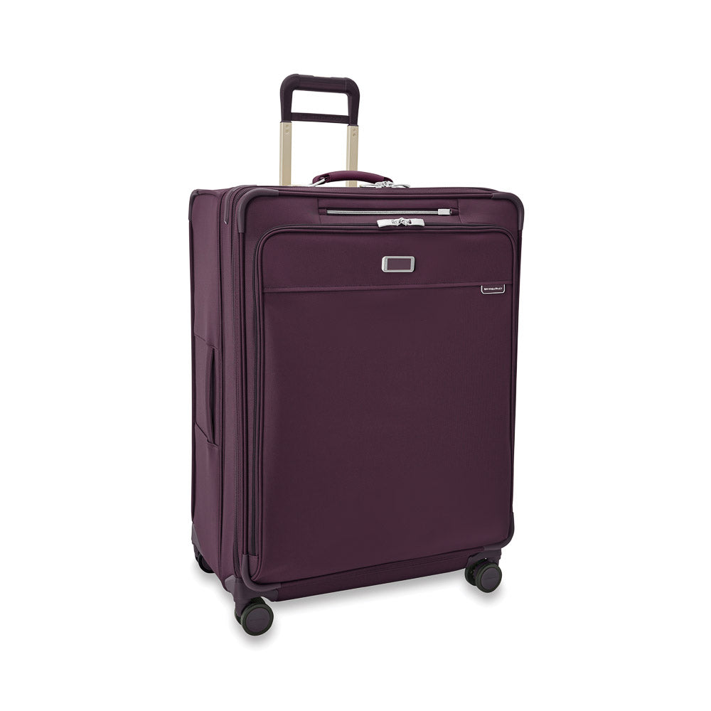 Extra large expandable spinner suitcase in plum by Briggs & Riley, showcasing a durable exterior and spacious interior.