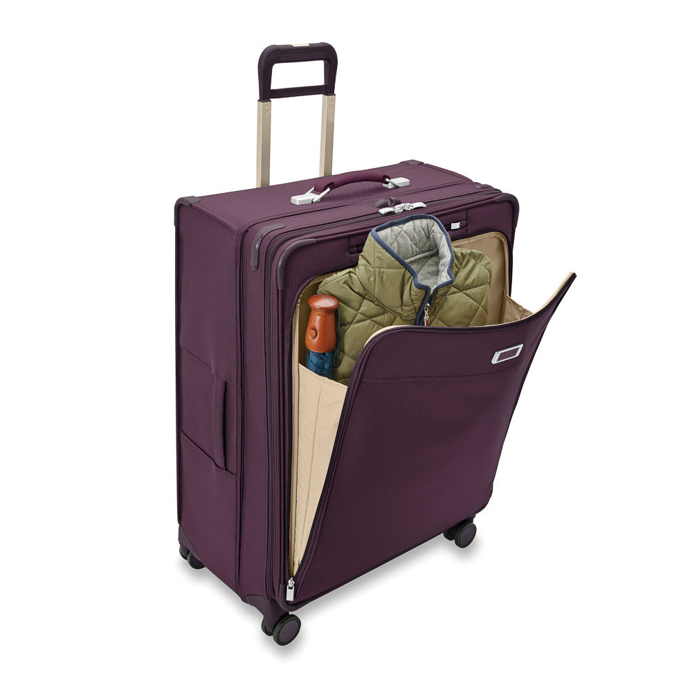 Extra large expandable spinner suitcase in plum by Briggs & Riley, showcasing durable design and spacious interior.