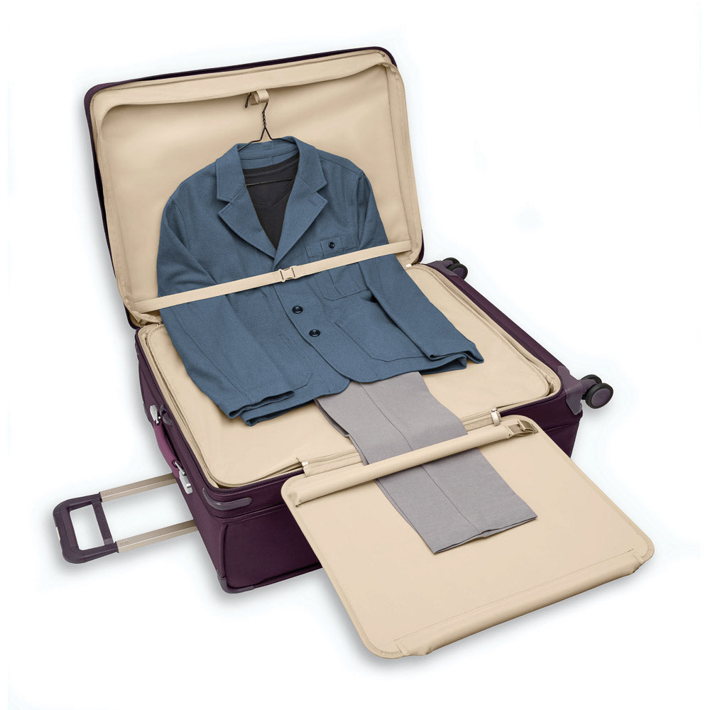 Extra large expandable spinner suitcase in plum by Briggs & Riley, featuring smooth wheels and durable exterior.