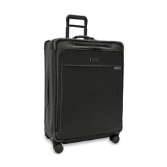 Briggs & Riley Baseline 2 large expandable spinner suitcase in black with 360-degree wheels and sturdy handle.