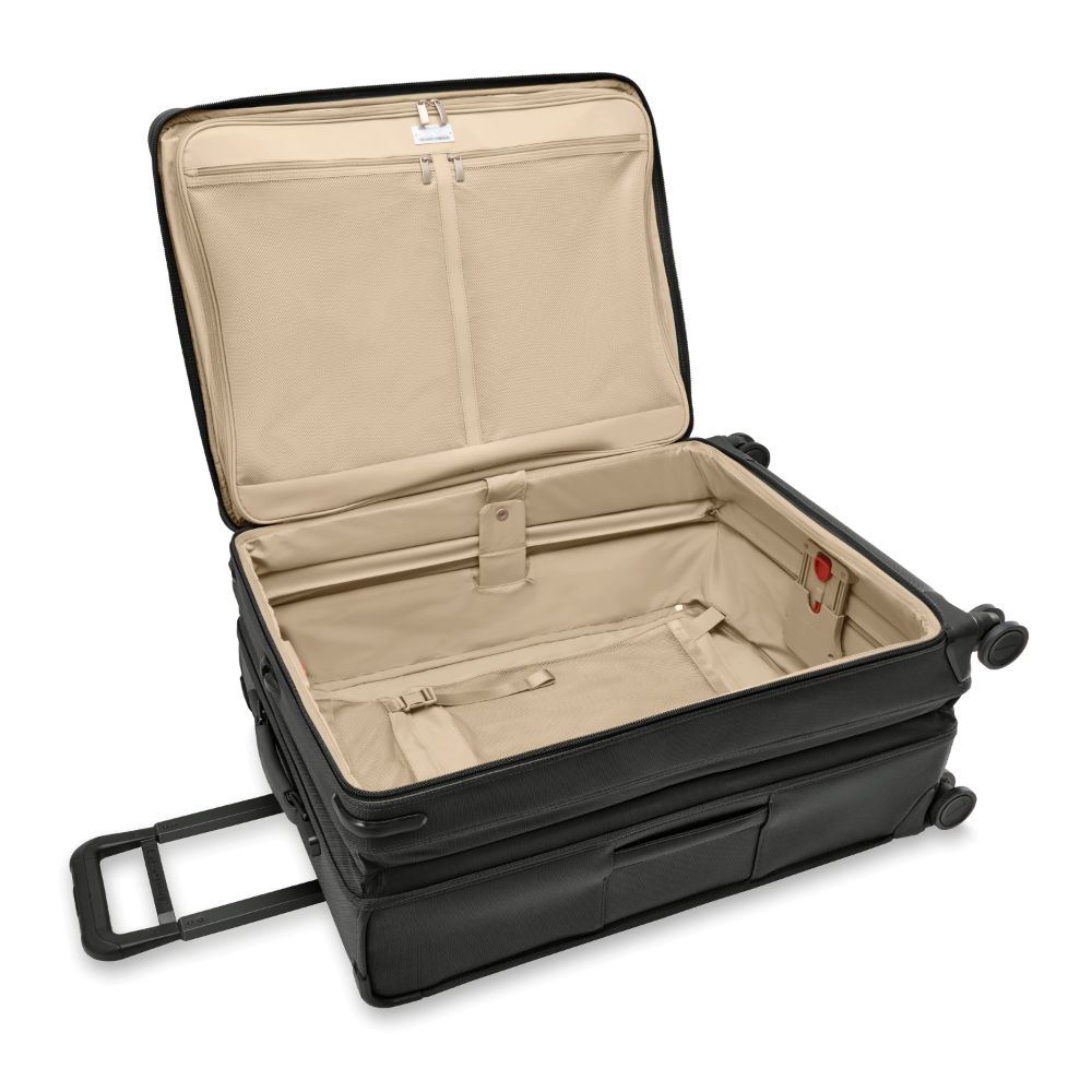 Large expandable black spinner suitcase by Briggs & Riley, showcasing its durable design and spacious interior for travel.