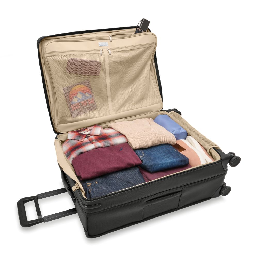 Large black expandable spinner suitcase by Briggs & Riley, featuring smooth wheels and durable fabric for travel convenience.