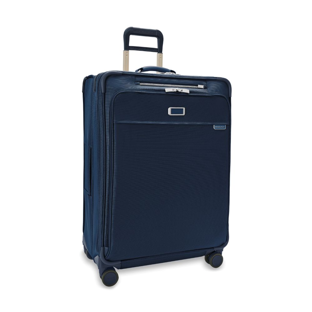 Large expandable spinner suitcase in navy blue from Briggs & Riley, showcasing smooth wheels and sturdy handle.