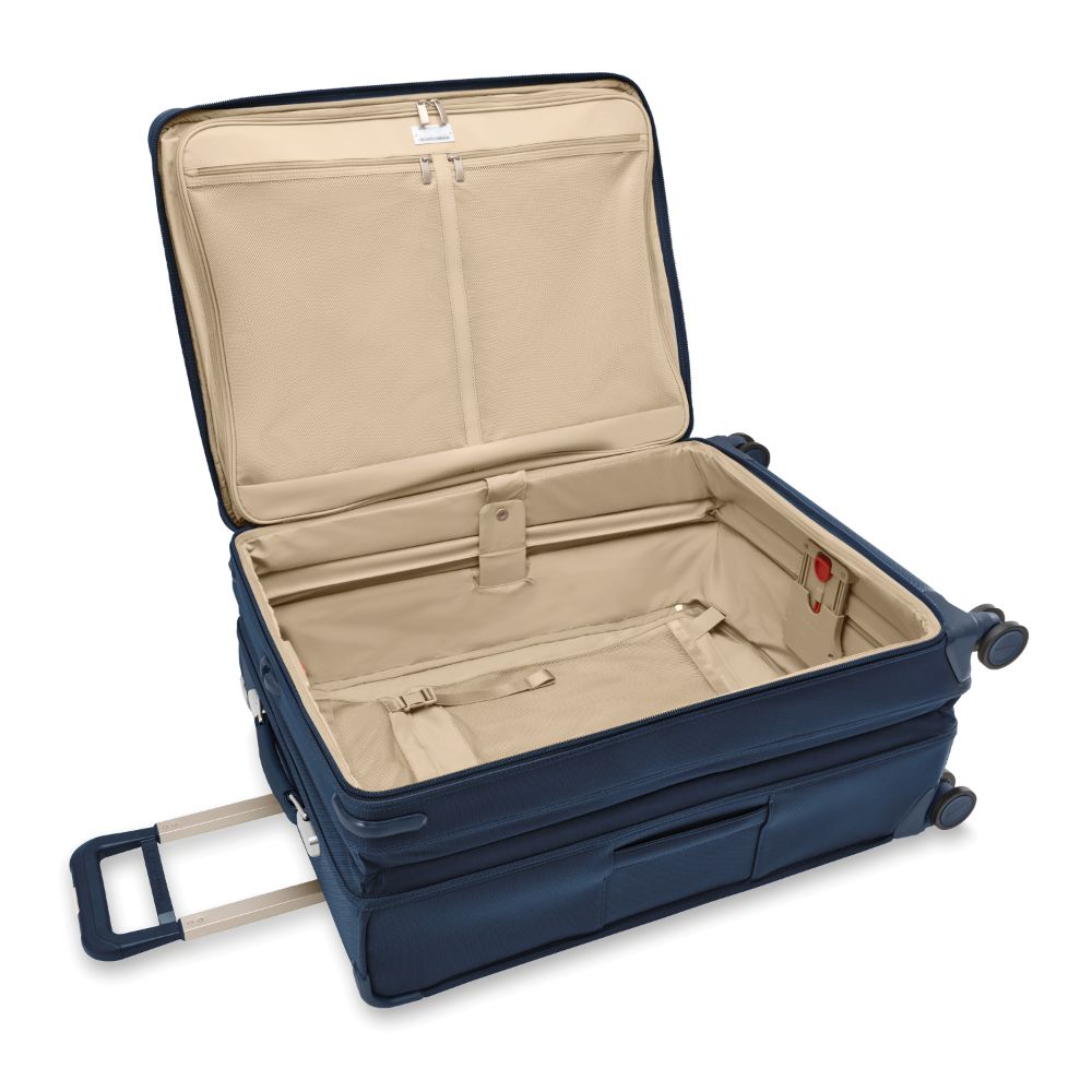 Large expandable spinner suitcase in navy from Briggs & Riley, featuring smooth wheels and spacious interior for travel.