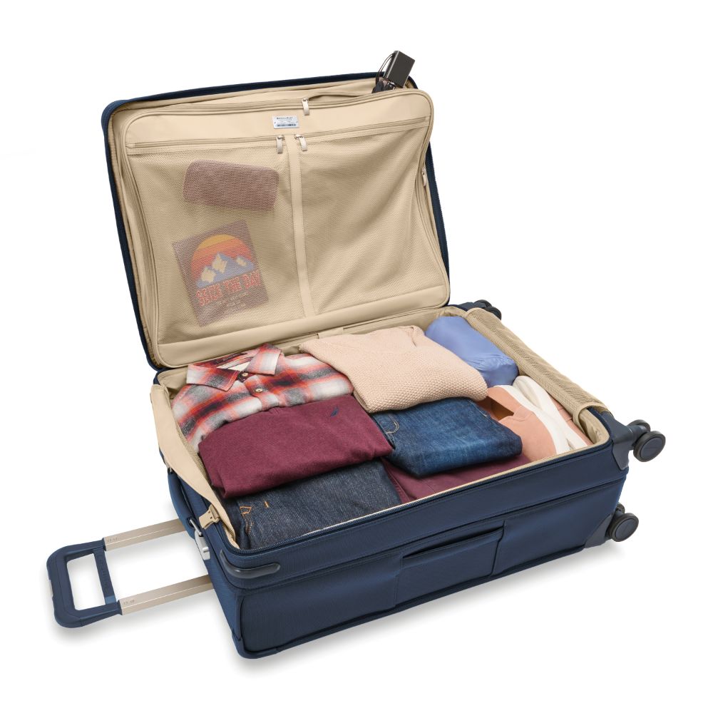 Navy large expandable spinner suitcase by Briggs & Riley, featuring durable design and smooth-rolling wheels for travel.