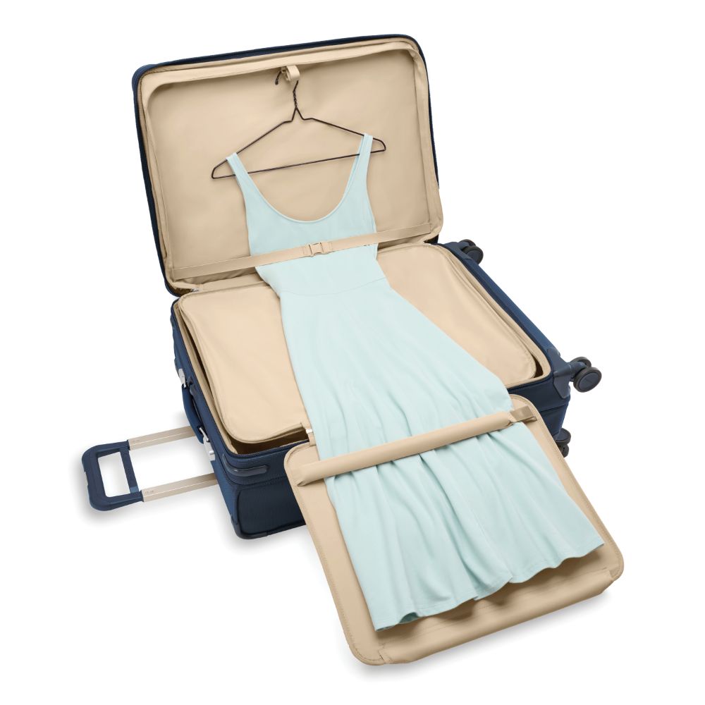 Briggs & Riley Baseline 2 large expandable spinner suitcase in navy blue, featuring four wheels and a spacious interior.