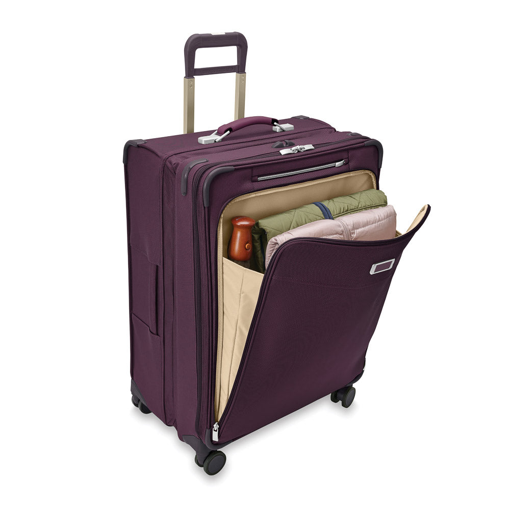 Large expandable spinner suitcase in plum by Briggs & Riley, showcasing durable design and spacious interior for check-in travel.