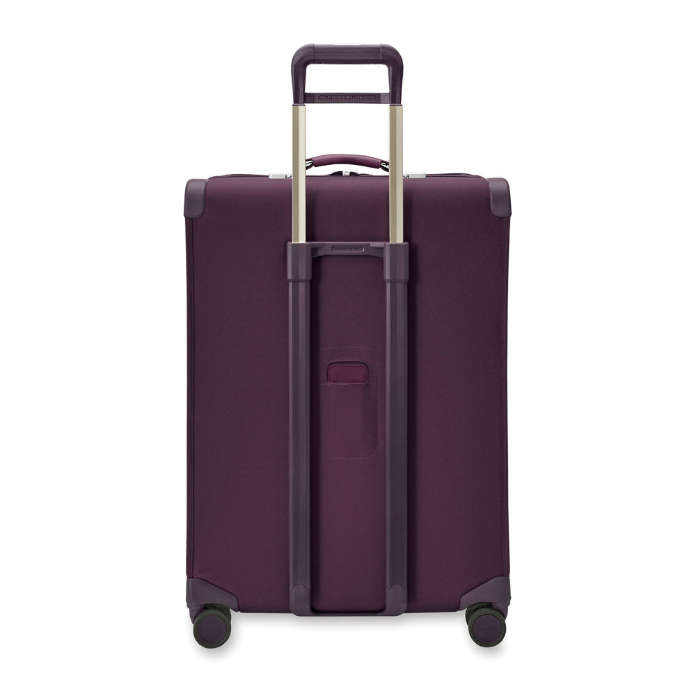 Large expandable spinner suitcase in plum by Briggs & Riley, featuring smooth wheels and spacious interior for check-in luggage.