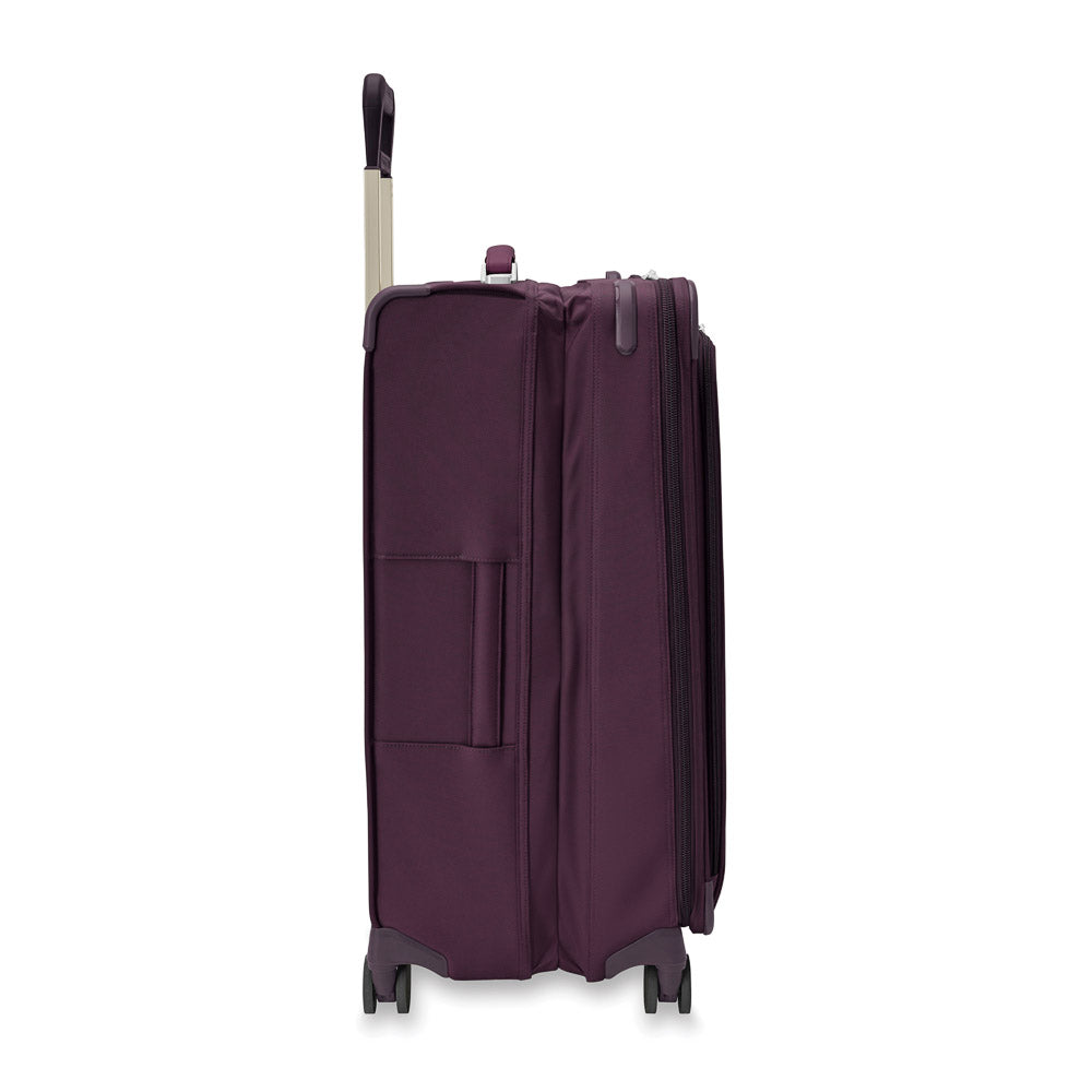 Large expandable spinner suitcase in plum color by Briggs & Riley, featuring durable wheels and spacious interior for travel.