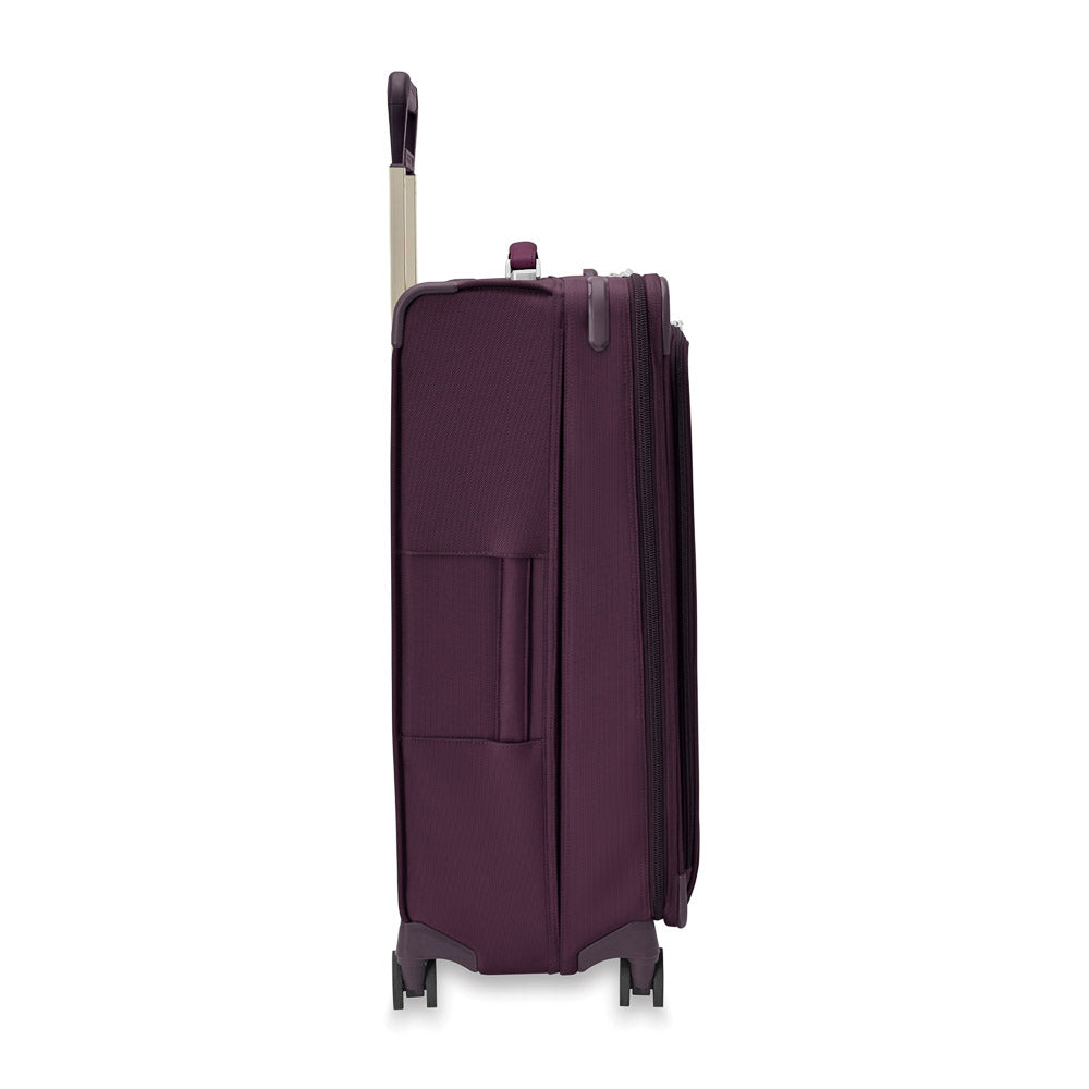 Briggs & Riley Baseline 2 large expandable spinner suitcase in plum color, showcasing spacious interior and durable design.