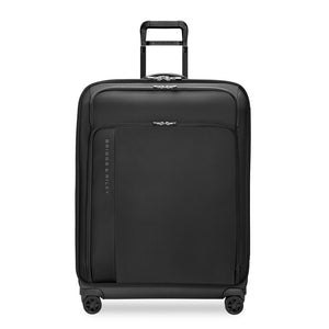 Large expandable spinner suitcase by Briggs & Riley in black, showcasing its durable exterior and spacious interior.