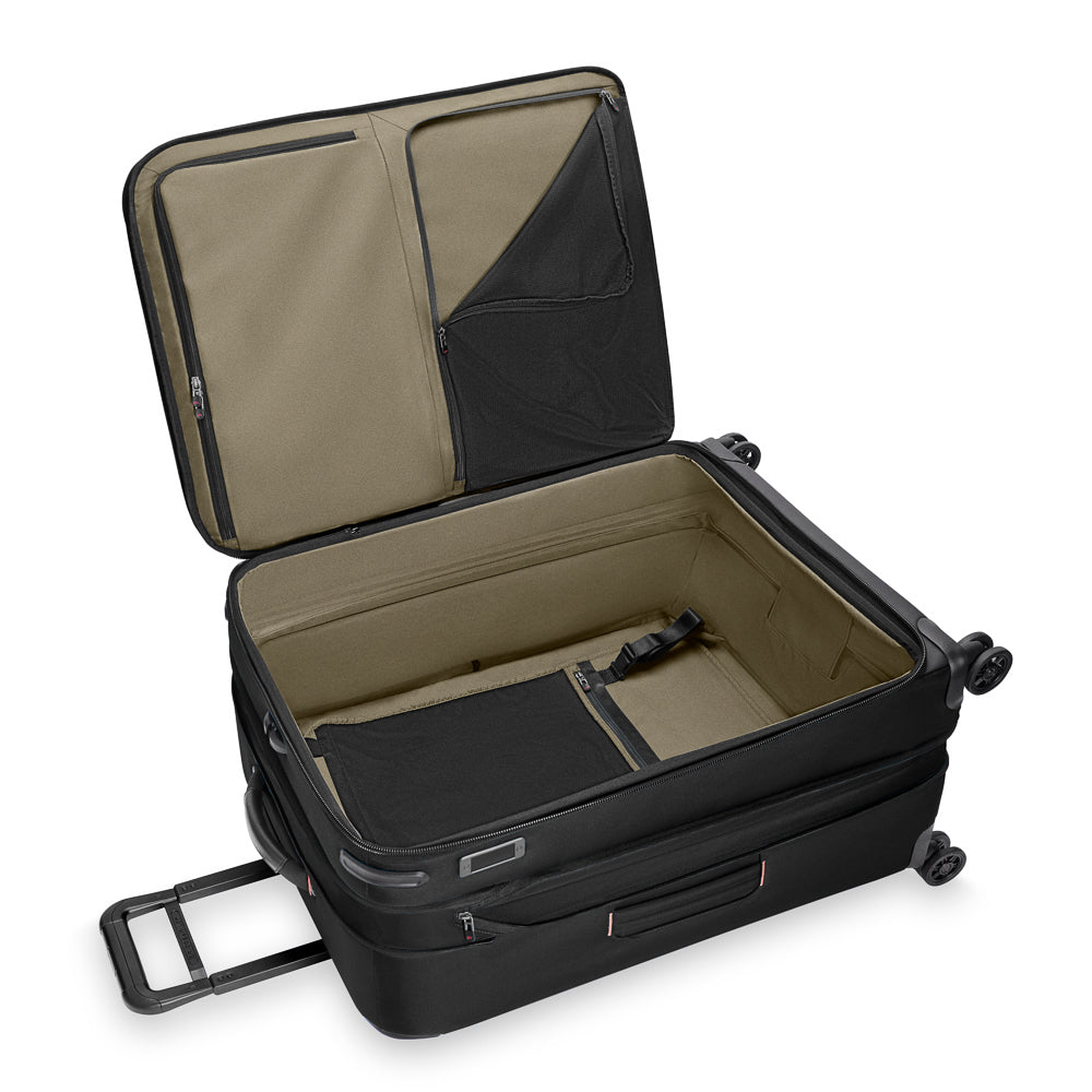 Briggs & Riley ZDX large expandable spinner suitcase in black, featuring four wheels and a sturdy handle for easy travel.