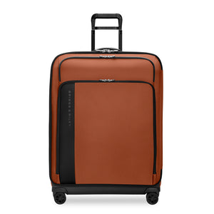 Large expandable spinner suitcase by Briggs & Riley in canyon color, featuring durable wheels and spacious interior for travel.