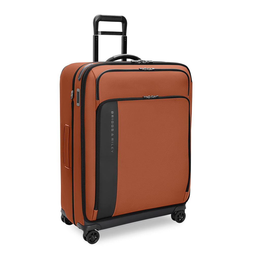 Large expandable spinner suitcase in Canyon color by Briggs & Riley, featuring durable wheels and spacious interior for travel.