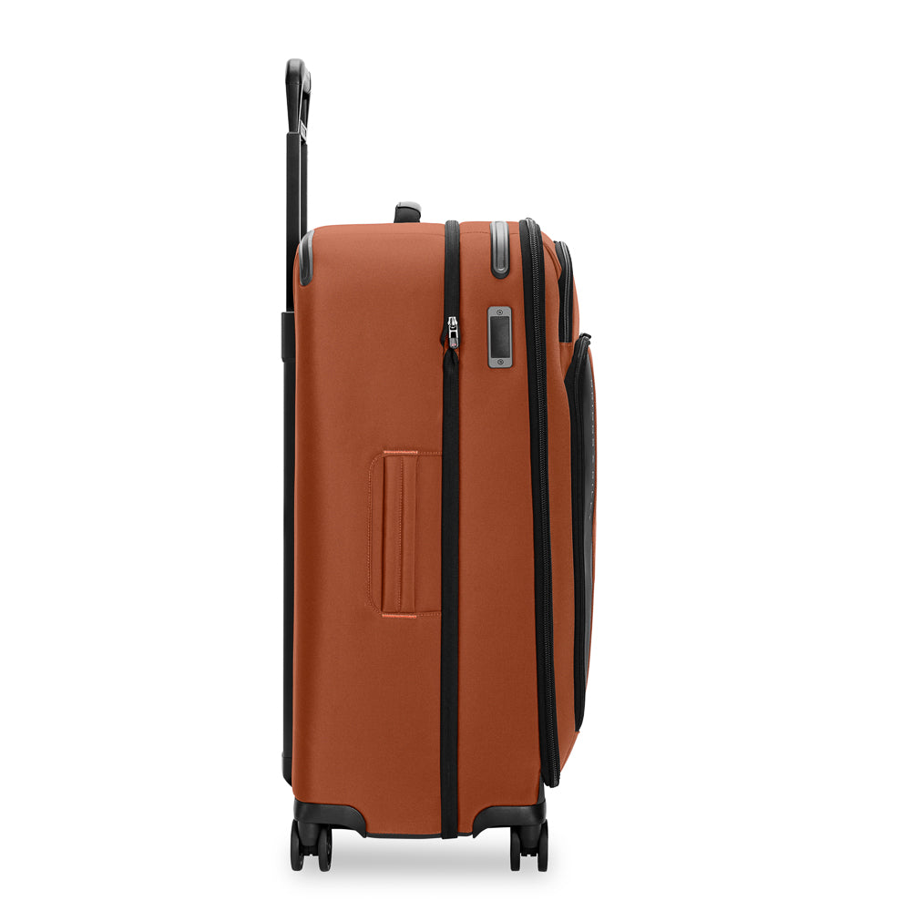 Large expandable spinner suitcase by Briggs & Riley in Canyon color, showcasing durable design and spacious interior.