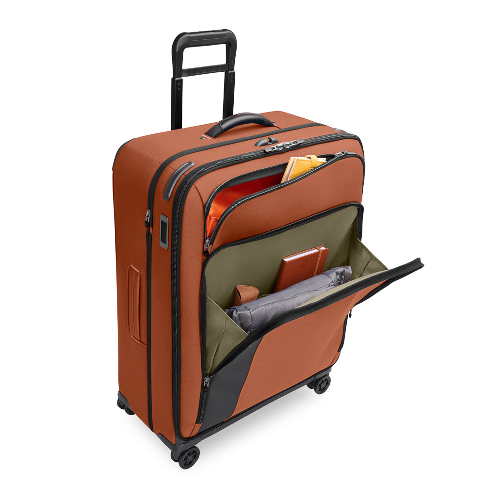 Large expandable spinner suitcase in Canyon color by Briggs & Riley, showcasing sleek design and spacious compartments.