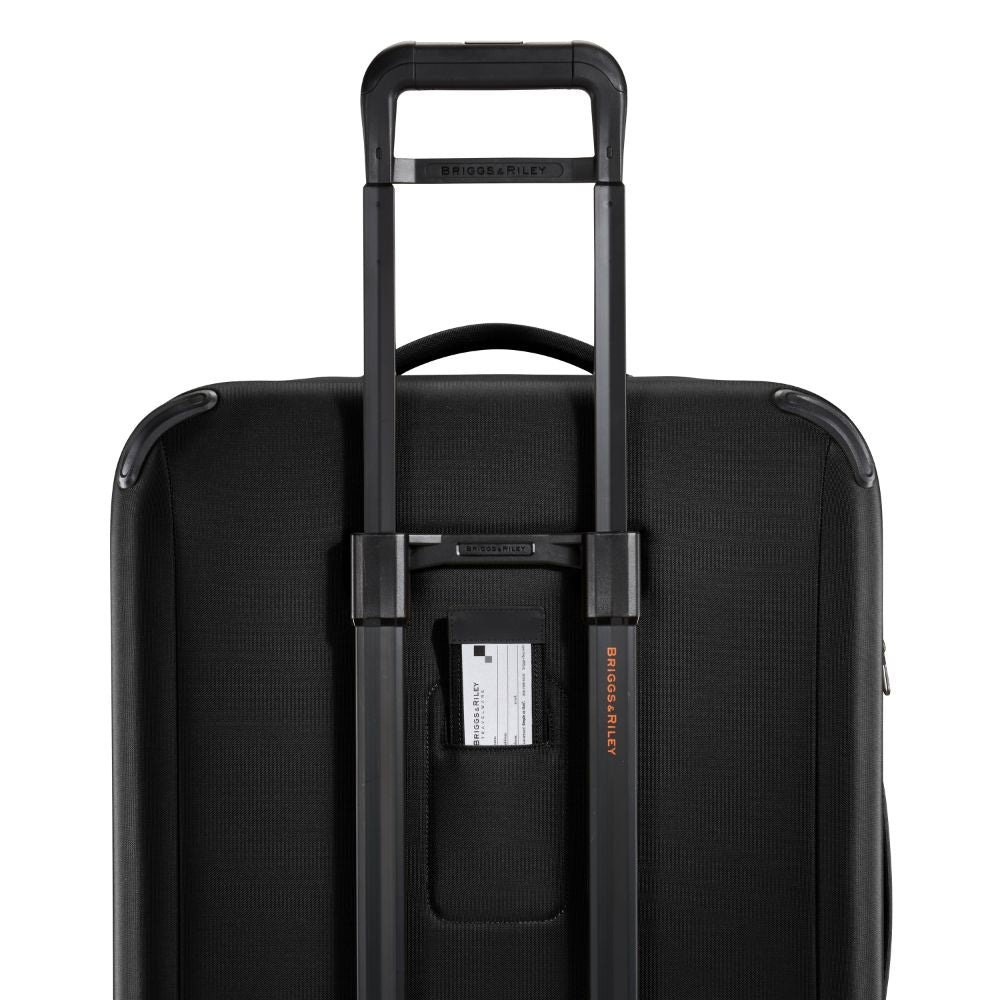 Large black Briggs & Riley ZDX check-in luggage spinner with smooth wheels and sturdy handle.