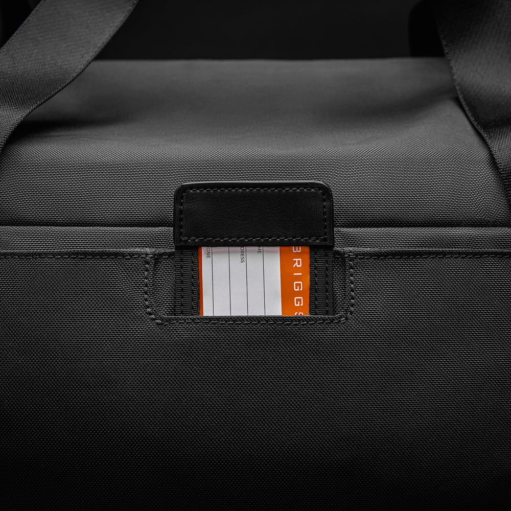 Large black travel duffle bag by Briggs & Riley, featuring durable fabric and spacious interior for travel essentials.