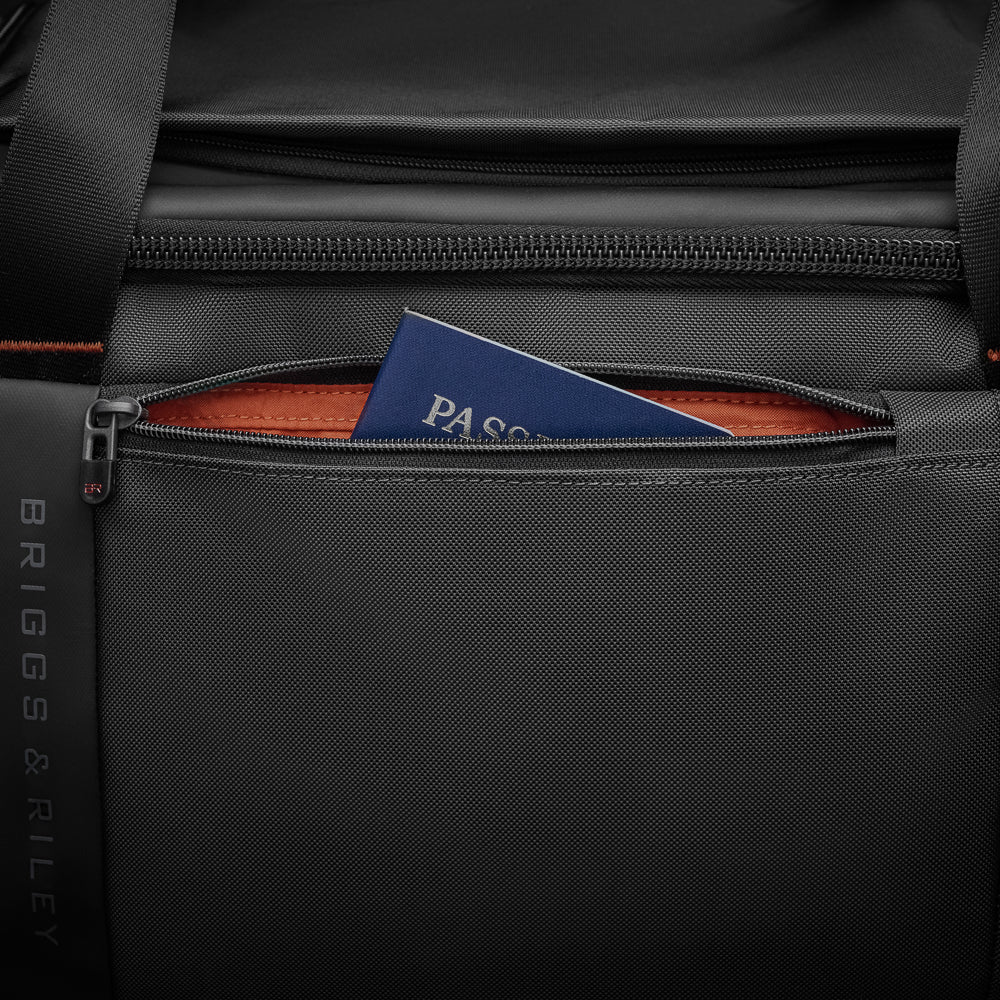 Large black travel duffle by Briggs & Riley, showcasing spacious design and durable fabric for travel convenience.